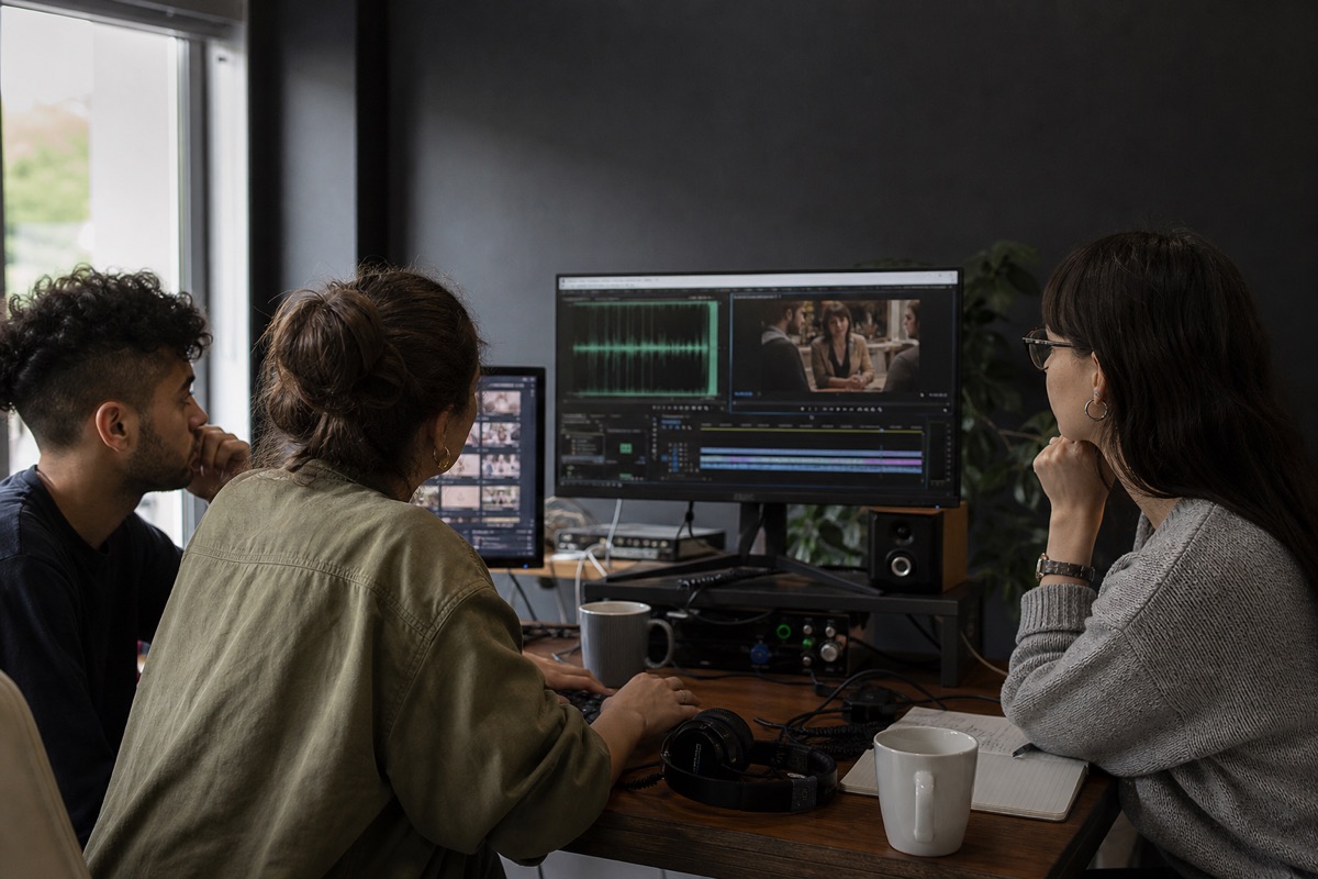 Small media team reviewing a recorded conversation